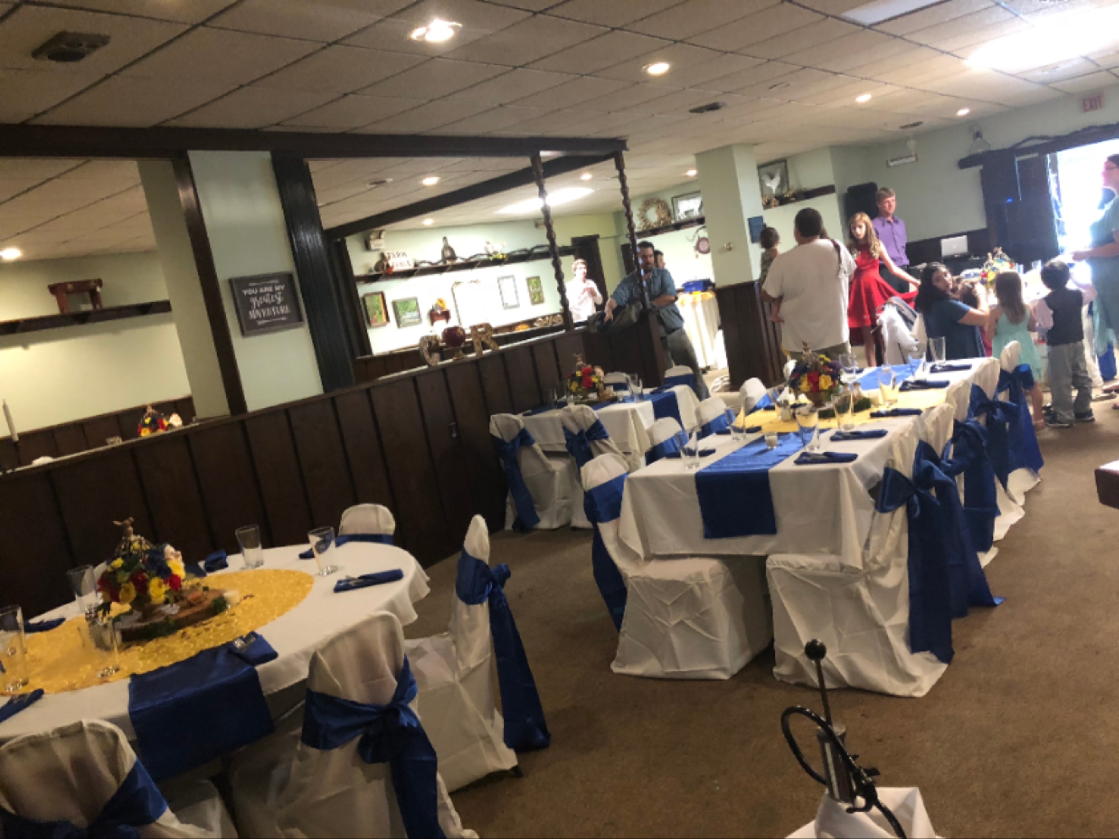 Elegant event space with catering table and formal dining setup